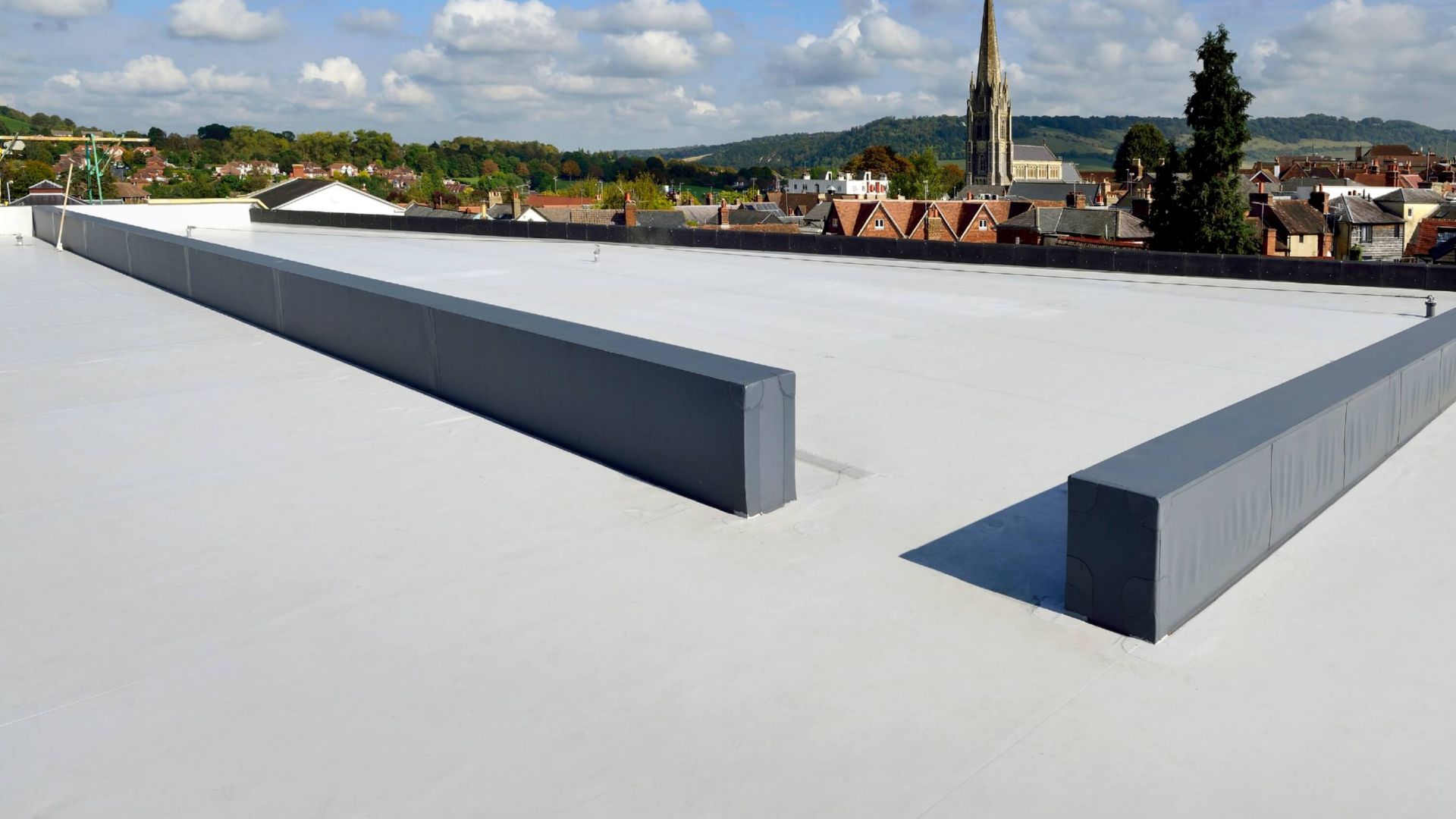 Single-ply membrane roofing system on a completed flat roof